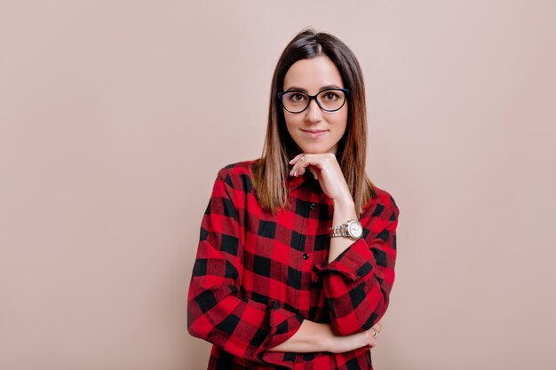 Pretty smart female dressed shirt and glasses, looking with satisfaction at front, being happy – Free Stock Photos