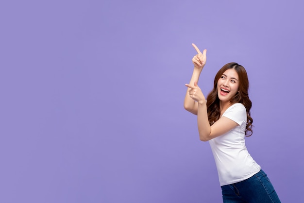 Pretty smiling asian woman pointing hand