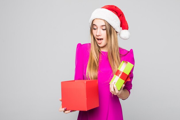 Pretty smiling funny happy lady in short dress and new year hat hold paper box surprise in her hands