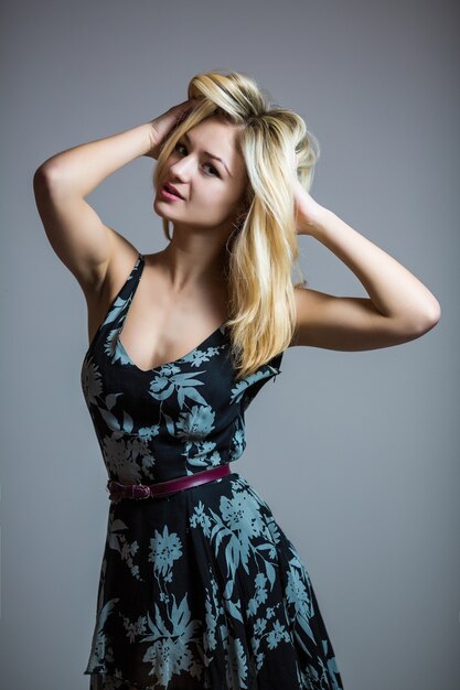 Pretty smiling good-looking beautiful woman isolated against blank studio wall.