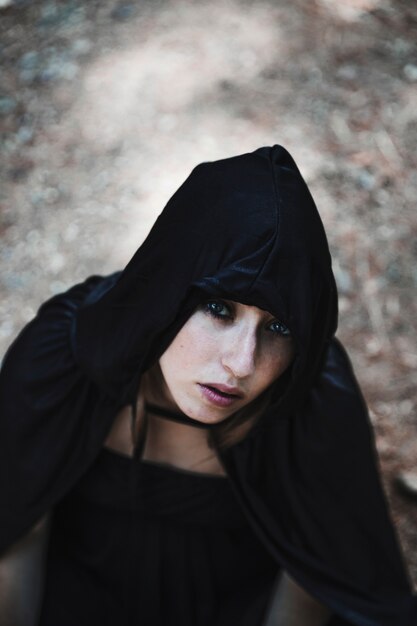 Pretty sorceress in black hood