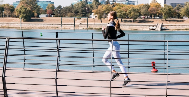 かなりスポーティな若い女性が公園でジョギング