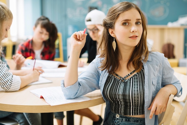 Pretty student posing in class