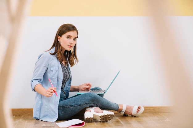 Free photo pretty student posing with gadget