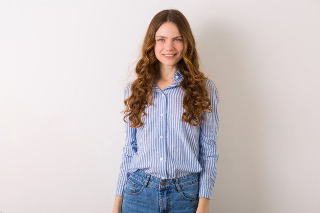 Pretty stylish young woman posing in denim style outfit on white