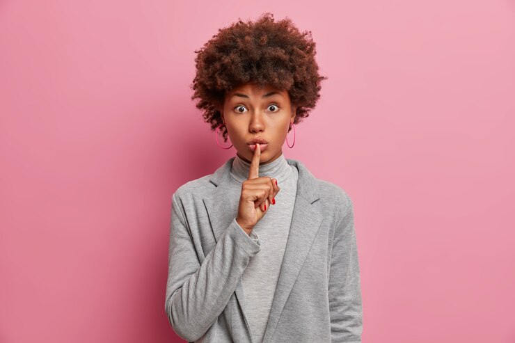 Free Photo pretty surprised businesswoman makes silence gesture, tells secret about how to start own business