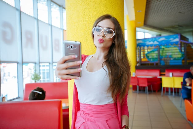 Pretty teen sending a kiss for the photo