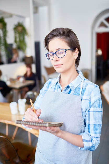 Pretty Waitress Wrapped up in Work