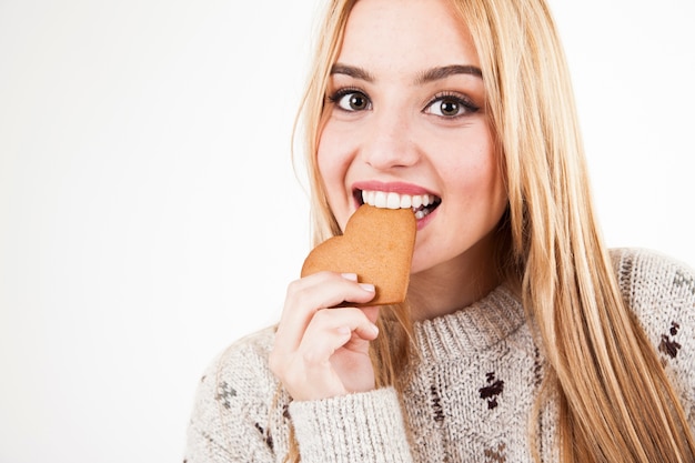 Pretty woman biting cookie