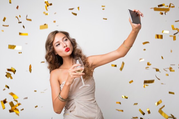 Pretty woman celebrating new year drinking champagne