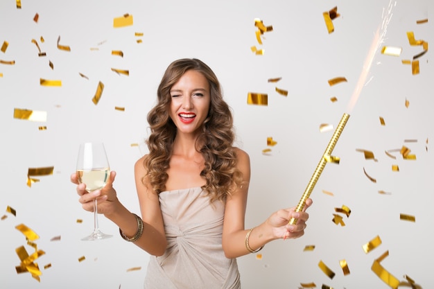pretty woman celebrating new year in golden confetti