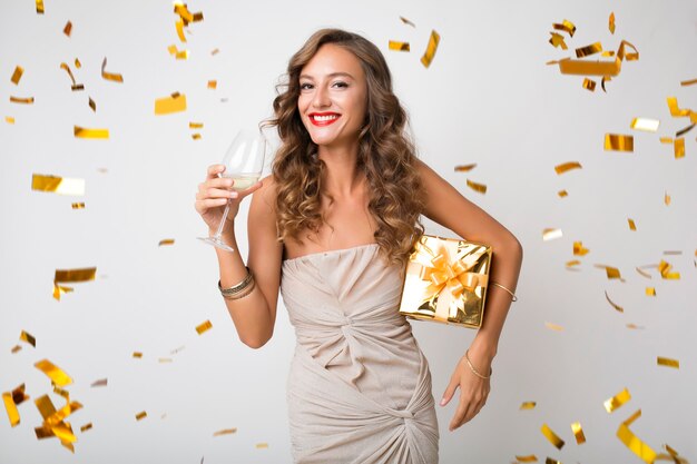 Pretty woman celebrating new year holding presents
