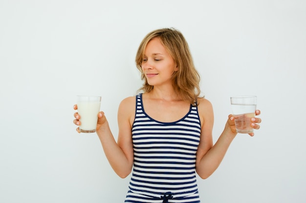 Pretty Woman Choosing Between Water and Milk