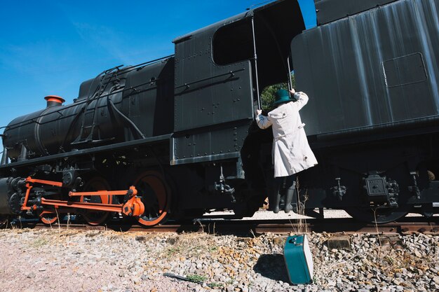 Pretty woman climbing on vintage train