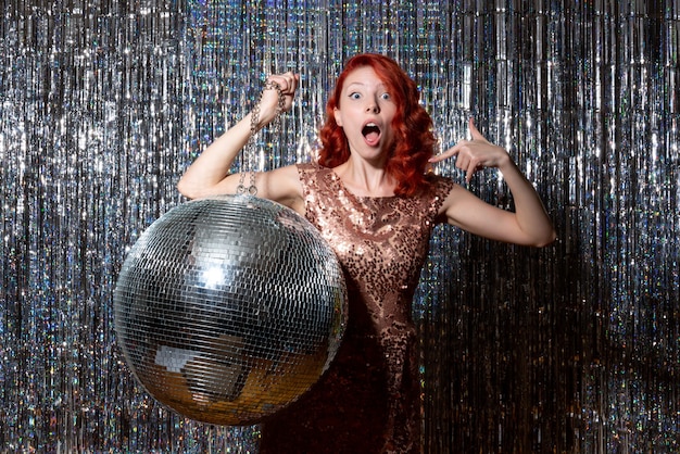 Free photo pretty woman in disco party with disco ball