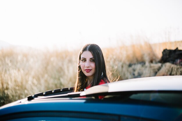 Pretty woman getting out car