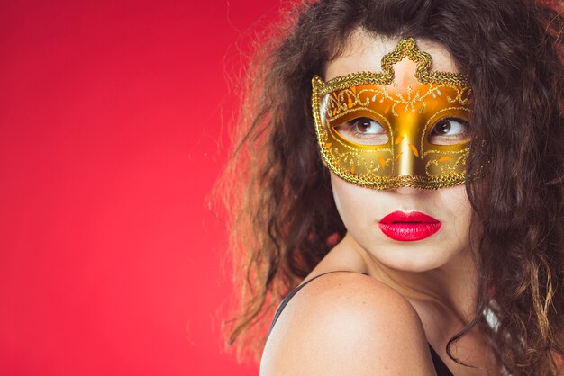 Pretty woman in golden mask