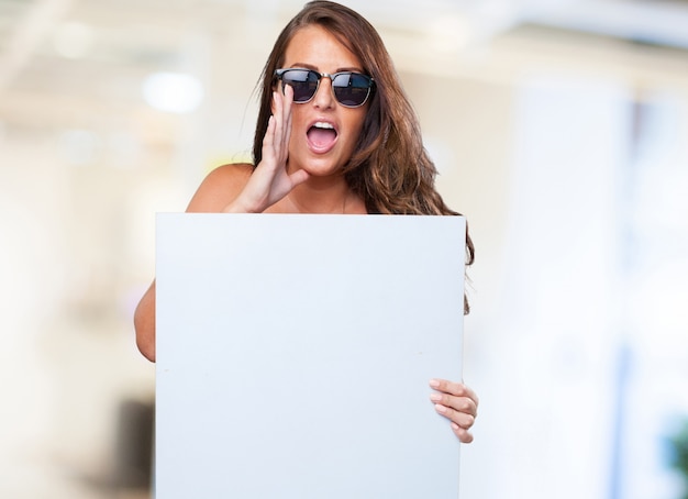 Free photo pretty woman holding a banner