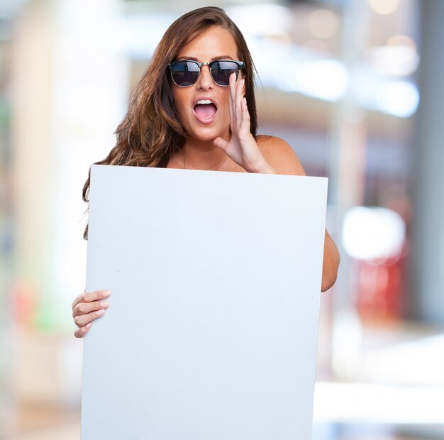 Free photo pretty woman holding a banner