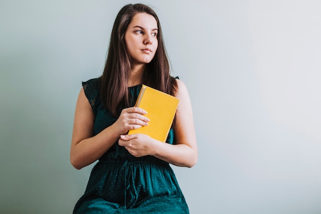 Pretty woman holding book