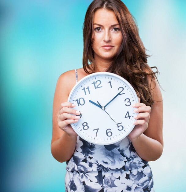 pretty woman holding a clock