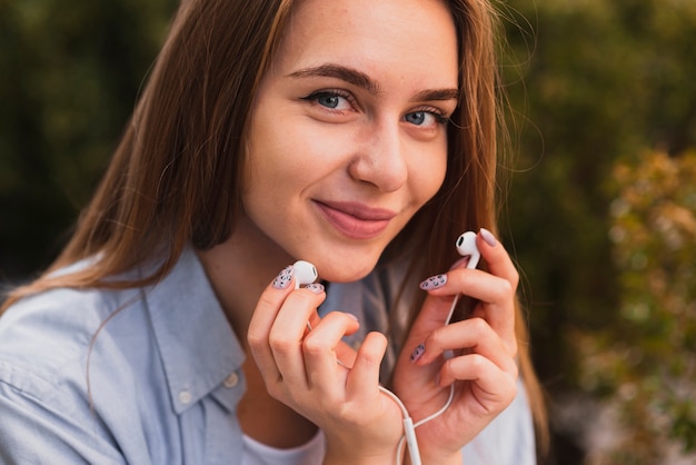 Pretty woman holding earphones