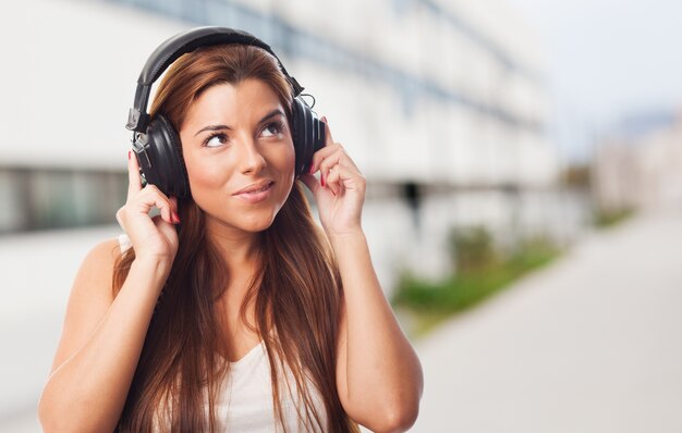 Pretty woman listening music in headphones