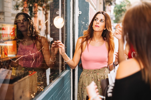 Pretty woman looking at shop-window