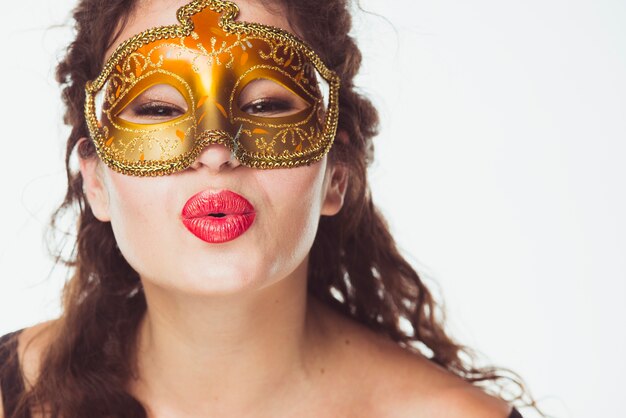 Pretty woman in mask kissing air