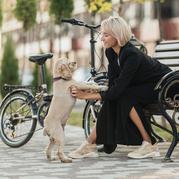 Pretty woman petting her cute dog