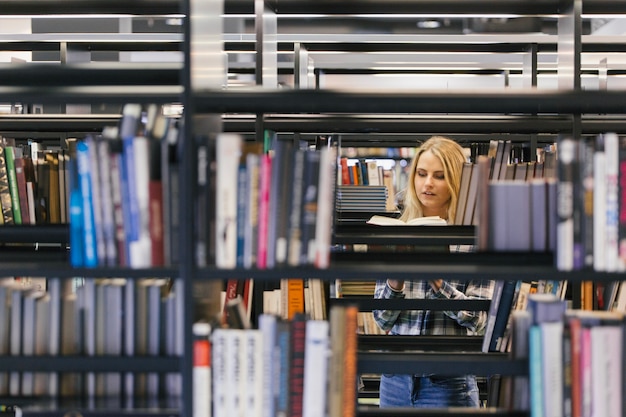 Pretty woman picking literature