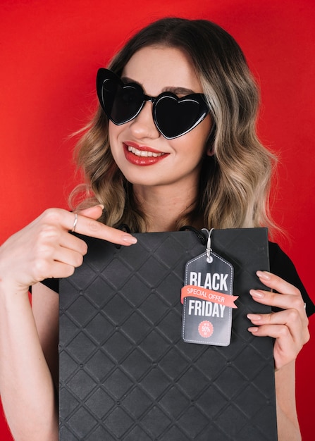 Pretty woman pointing on bag from black friday 