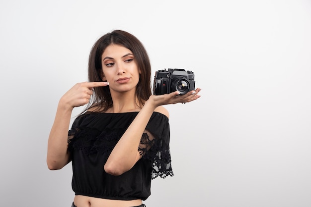 Free photo pretty woman pointing at camera