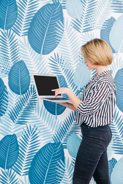 Pretty woman pointing at laptop