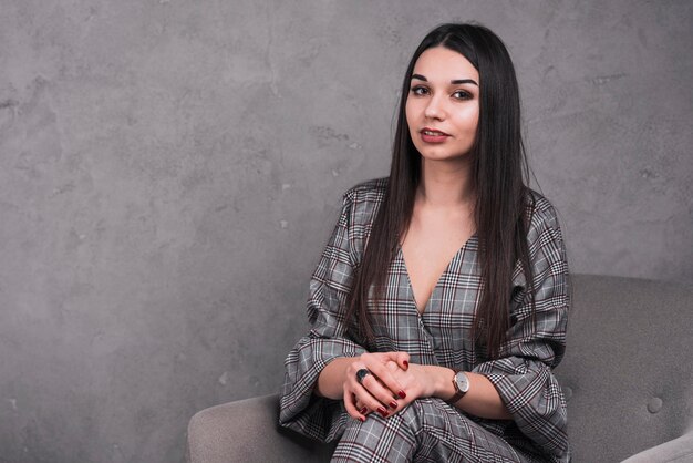 Pretty woman posing in armchair