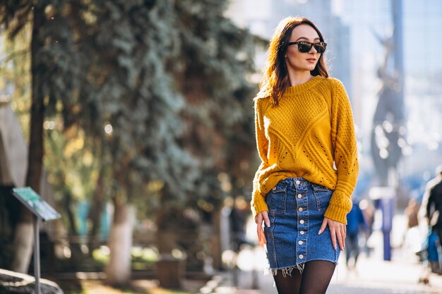 Pretty woman posing in an autumn street