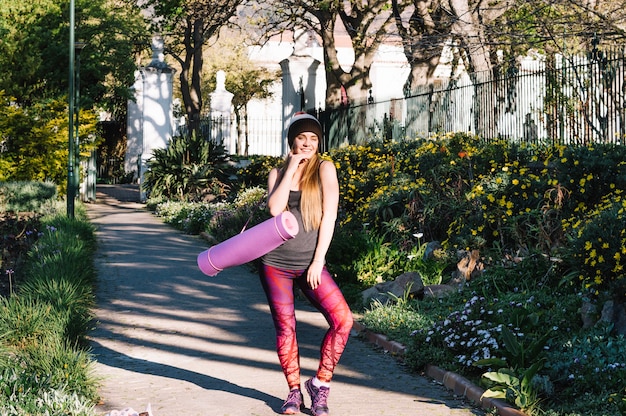 Pretty woman posing on park alley