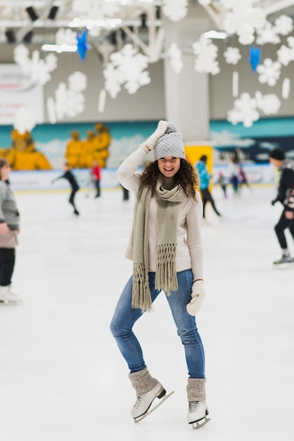 Pretty woman posing on skating rink