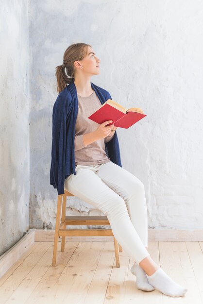 Pretty woman reading book at home