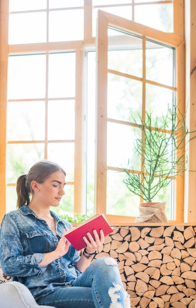 Pretty woman reading book at home