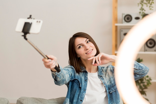 Pretty woman recording herself at home