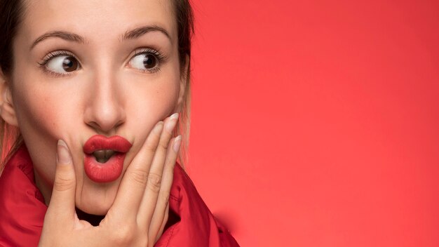 Pretty woman on red background 