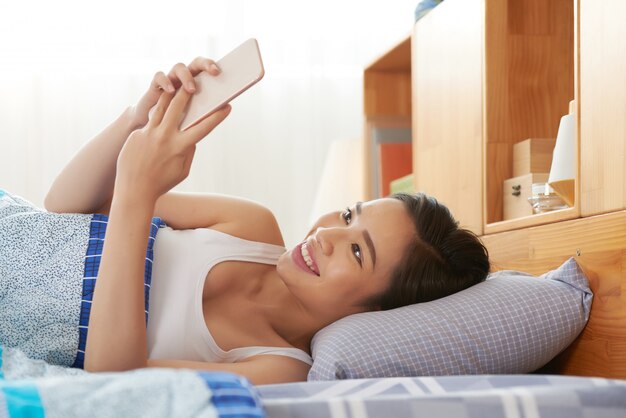 Pretty woman resting in bed