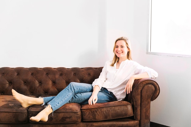 Pretty woman resting on couch