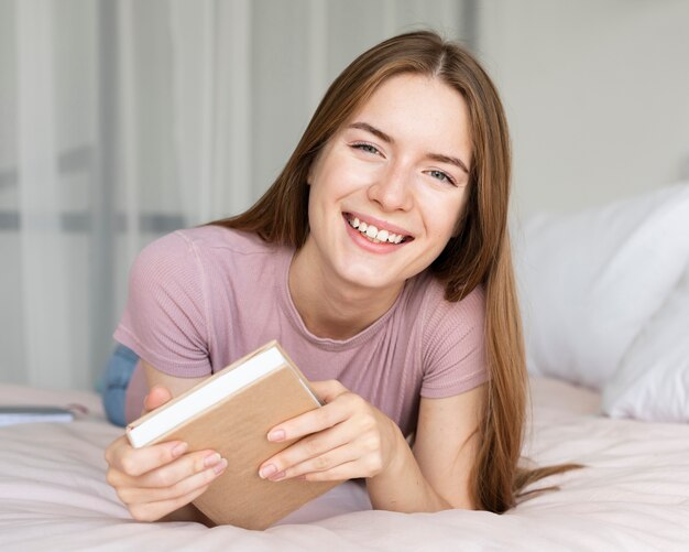 本を持ちながら笑顔のきれいな女性