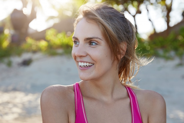 Pretty woman in sportswear on beach