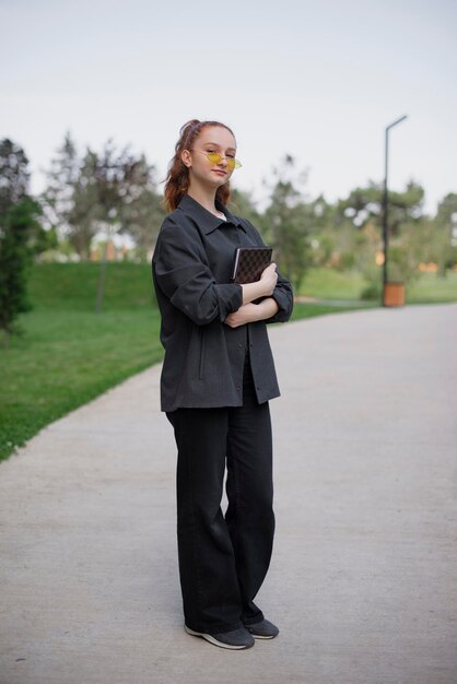 Pretty woman standing with crossed hands looking at camera