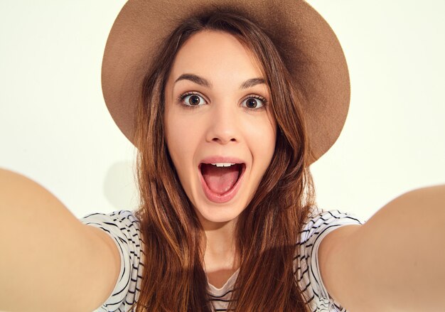 pretty woman in summer hipster clothes take selfie from hands with phone