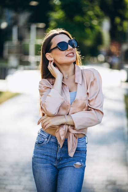 Pretty woman in summer outfit in park