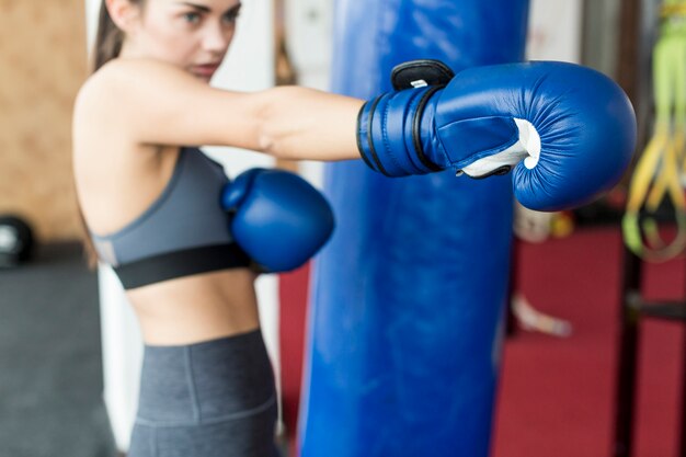 Pretty woman training to punch